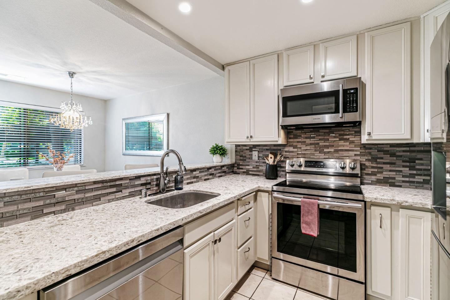 3400 La Terrace Circle San Jose, CA 95123 - Photo 10 of 39 a kitchen with stainless steel appliances granite countertop a sink stove and microwave