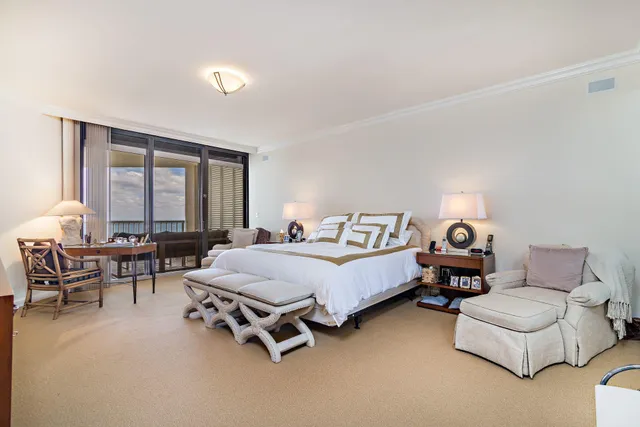 a bedroom with furniture and a large window