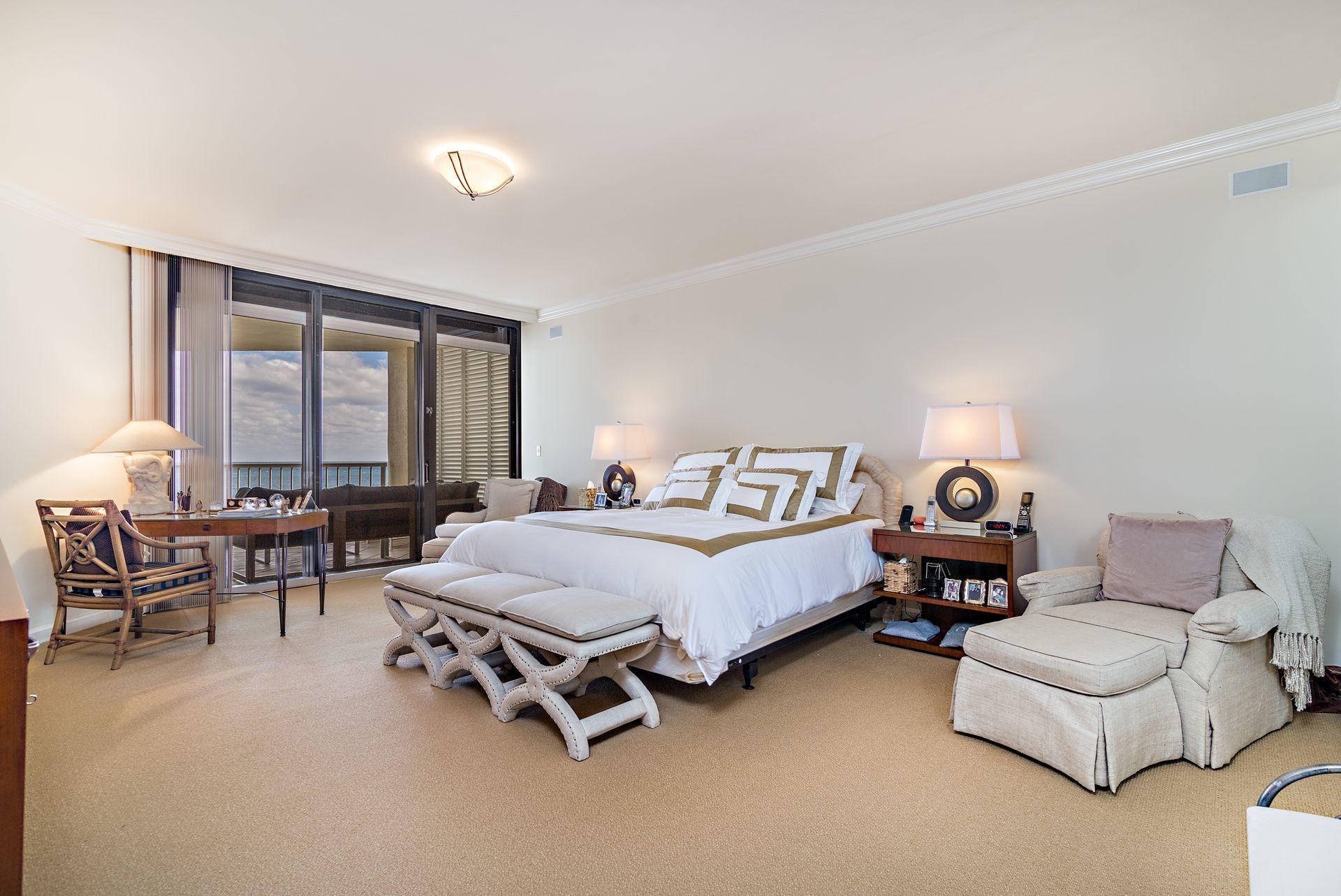 2770 South Ocean Boulevard, Unit 401S Palm Beach, FL 33480 - Photo 12 of 40 a bedroom with furniture and a large window