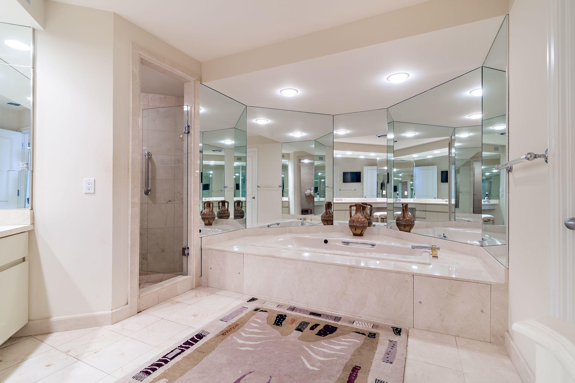 2770 South Ocean Boulevard, Unit 401S Palm Beach, FL 33480 - Photo 14 of 40 a bathroom with a sink mirror and a bath tub