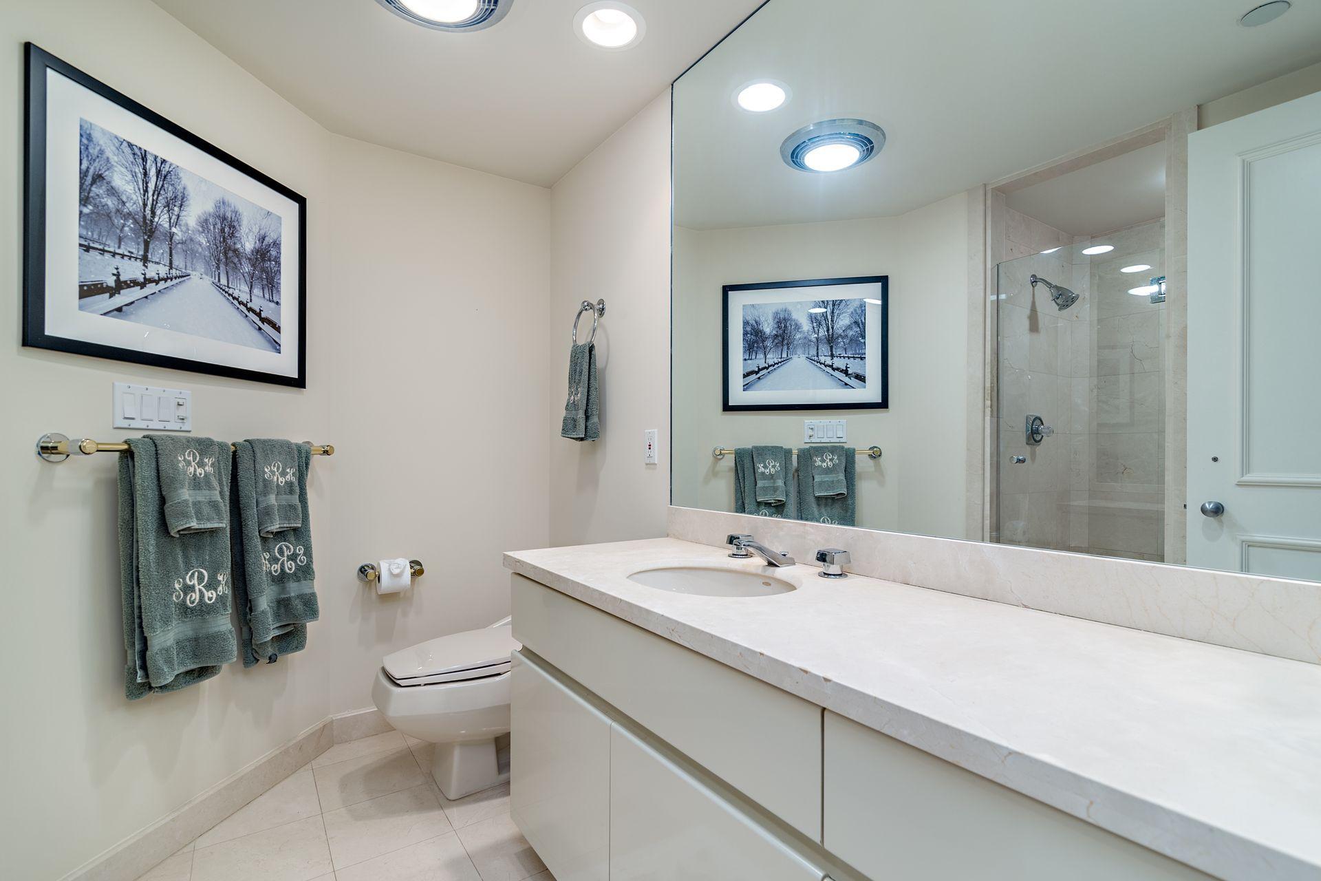 2770 South Ocean Boulevard, Unit 401S Palm Beach, FL 33480 - Photo 15 of 40 a bathroom with a toilet sink and mirror