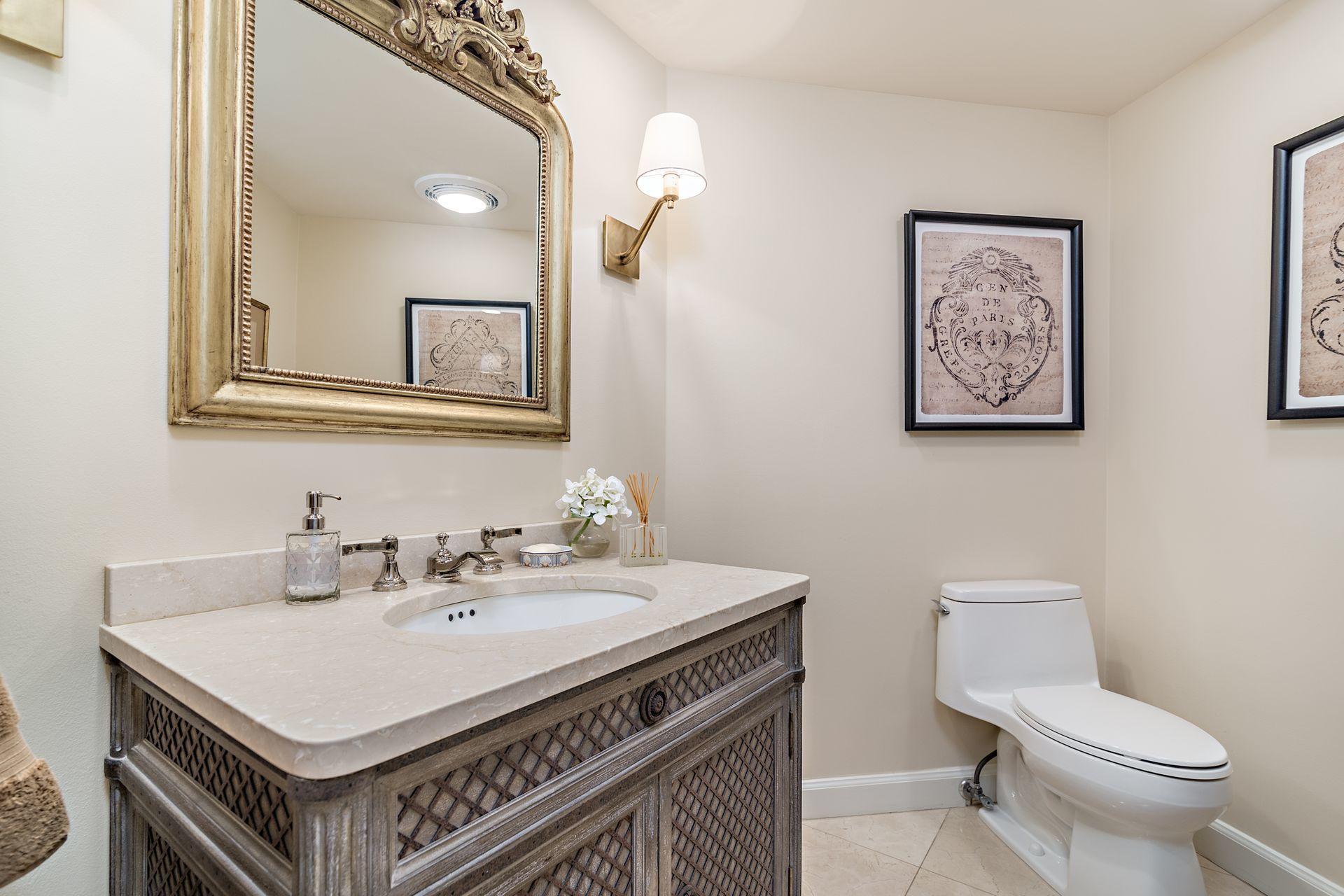 2770 South Ocean Boulevard, Unit 401S Palm Beach, FL 33480 - Photo 16 of 40 a bathroom with a sink a toilet and mirror