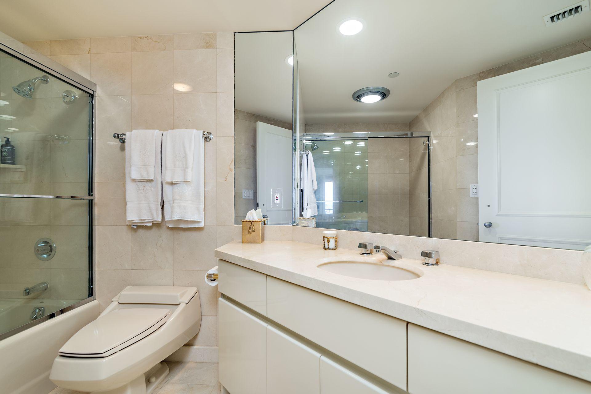 2770 South Ocean Boulevard, Unit 401S Palm Beach, FL 33480 - Photo 18 of 40 a bathroom with a sink a toilet a mirror and shower