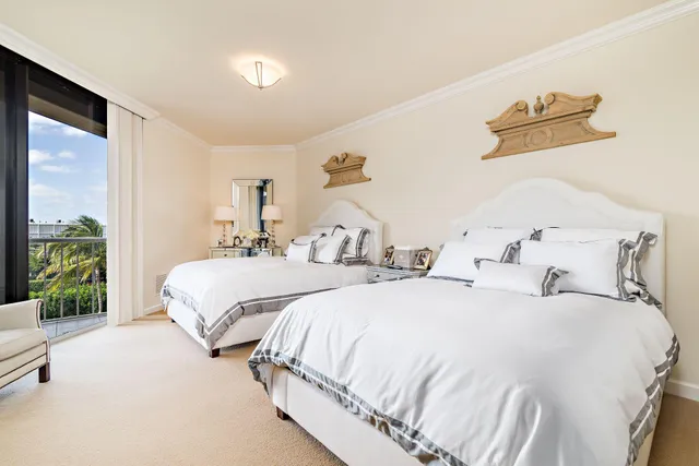 a spacious bedroom with two bed and a large window