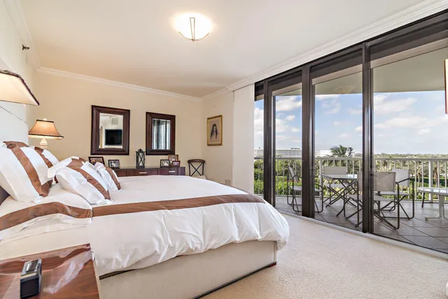 a bedroom with a large bed and a large window