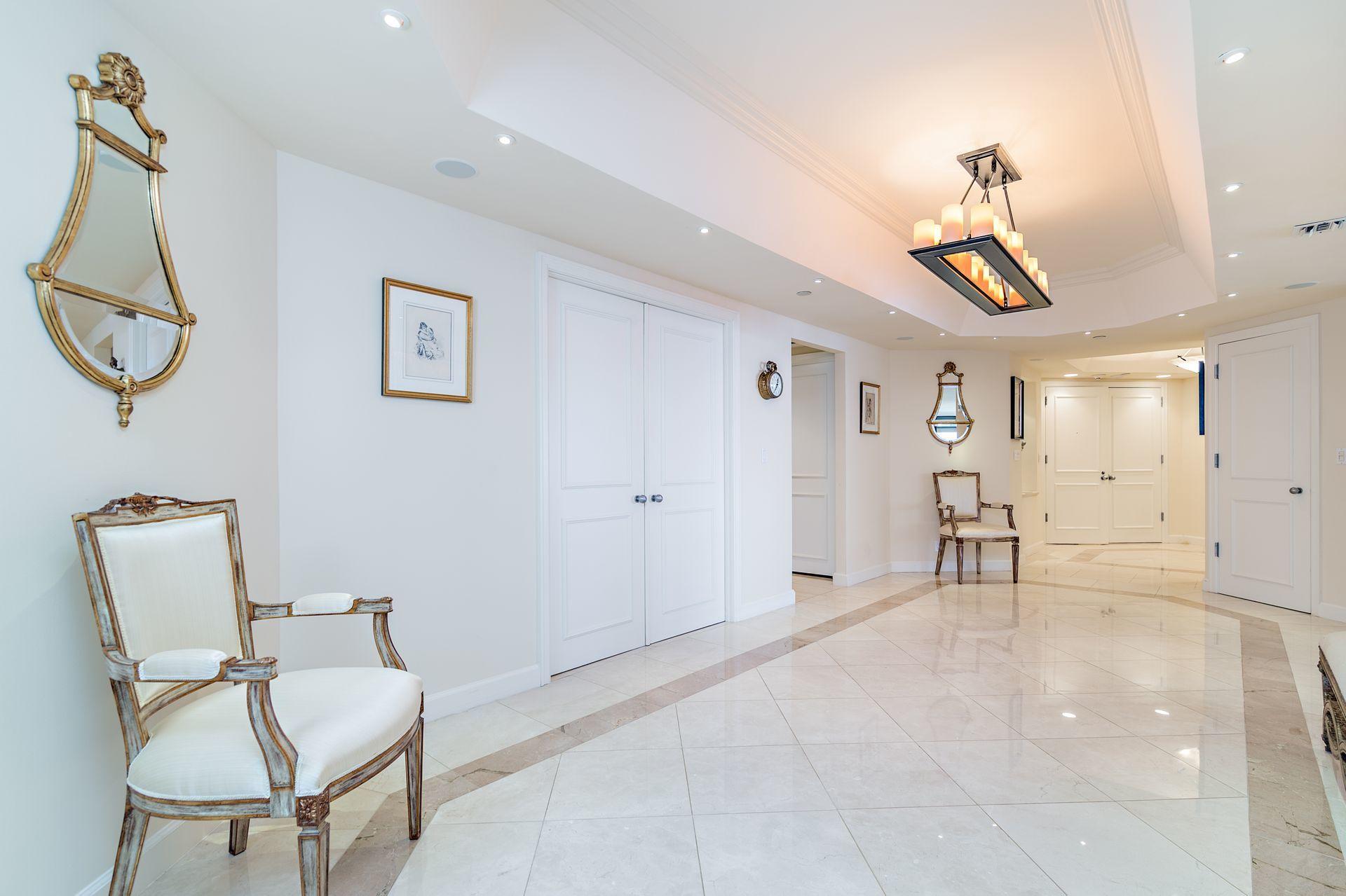 2770 South Ocean Boulevard, Unit 401S Palm Beach, FL 33480 - Photo 2 of 40 a dining room with wooden floor and a chandelier