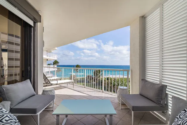 a balcony with furniture and a potted plant