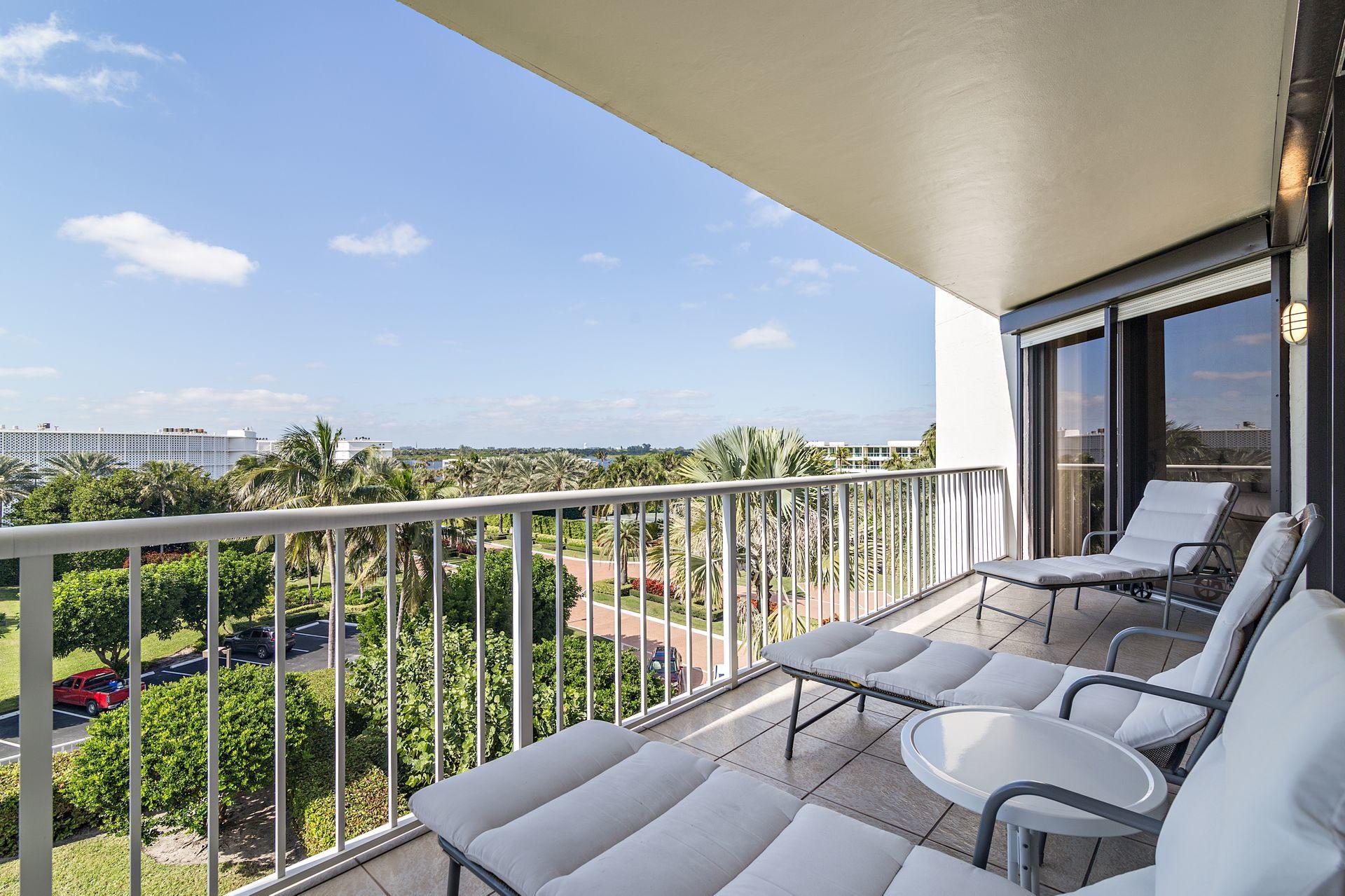 2770 South Ocean Boulevard, Unit 401S Palm Beach, FL 33480 - Photo 26 of 40 a view of roof deck with furniture and city view
