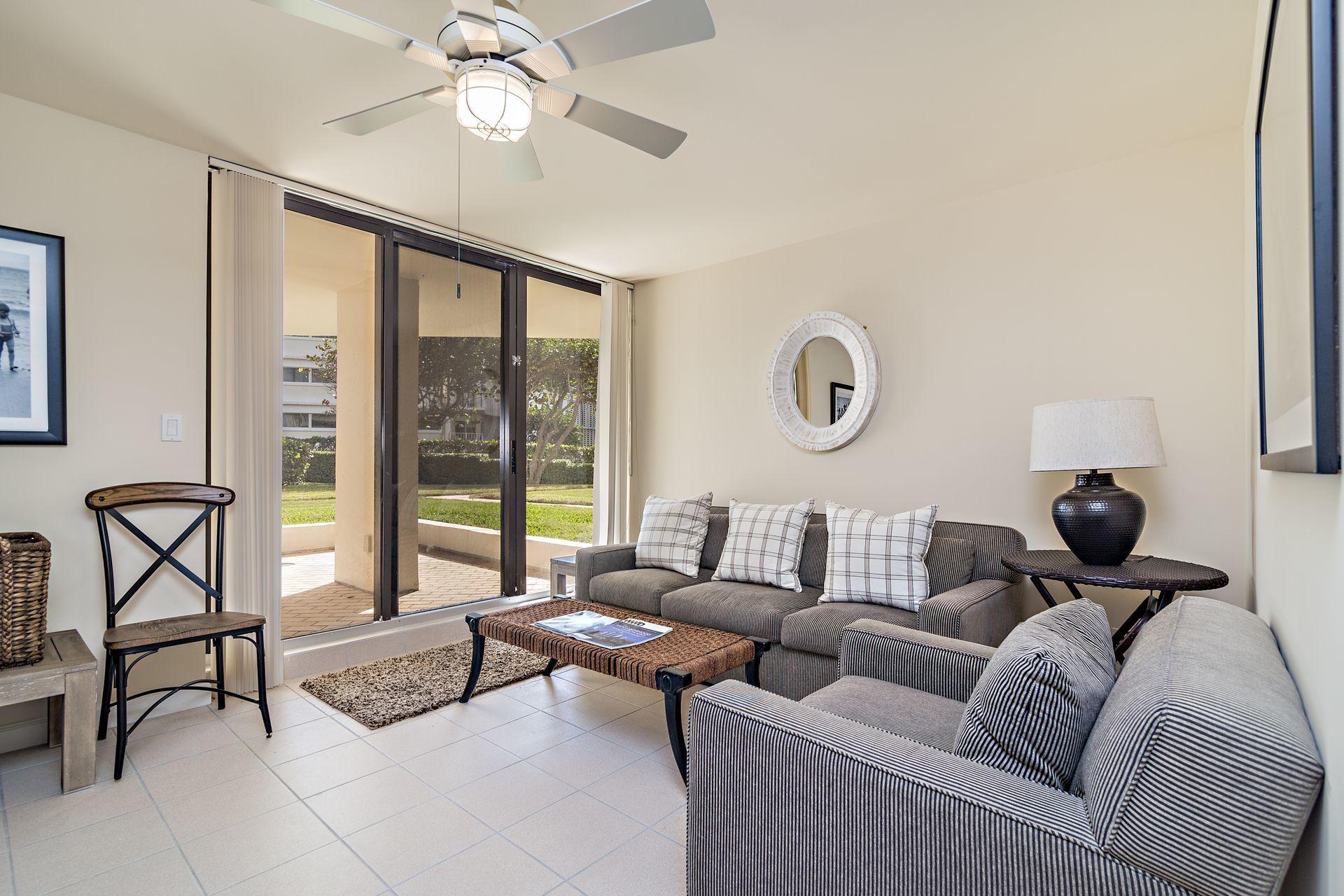 2770 South Ocean Boulevard, Unit 401S Palm Beach, FL 33480 - Photo 28 of 40 a living room with furniture a rug potted plant and a large window
