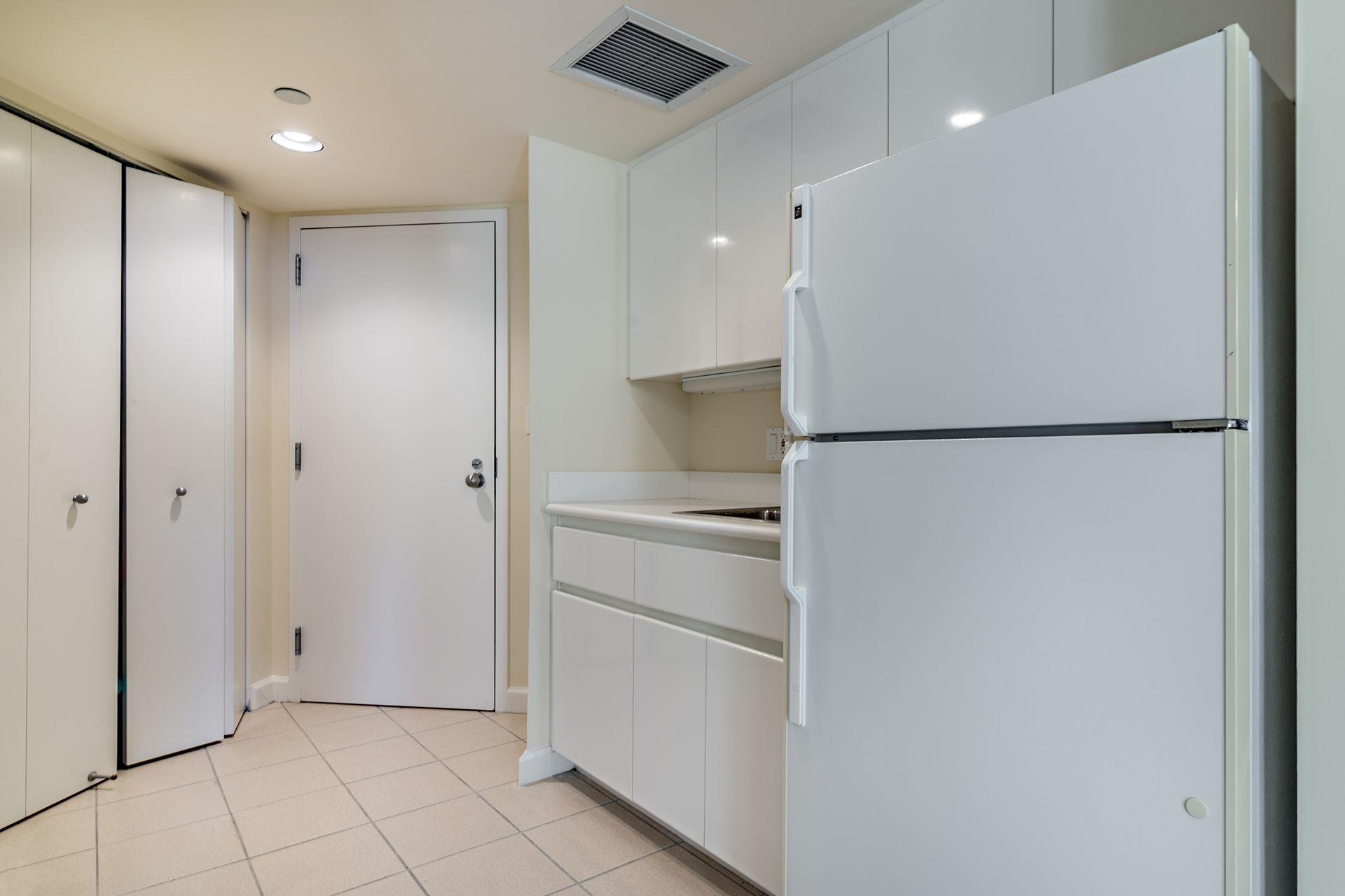 2770 South Ocean Boulevard, Unit 401S Palm Beach, FL 33480 - Photo 30 of 40 a view of a refrigerator in kitchen and an empty room