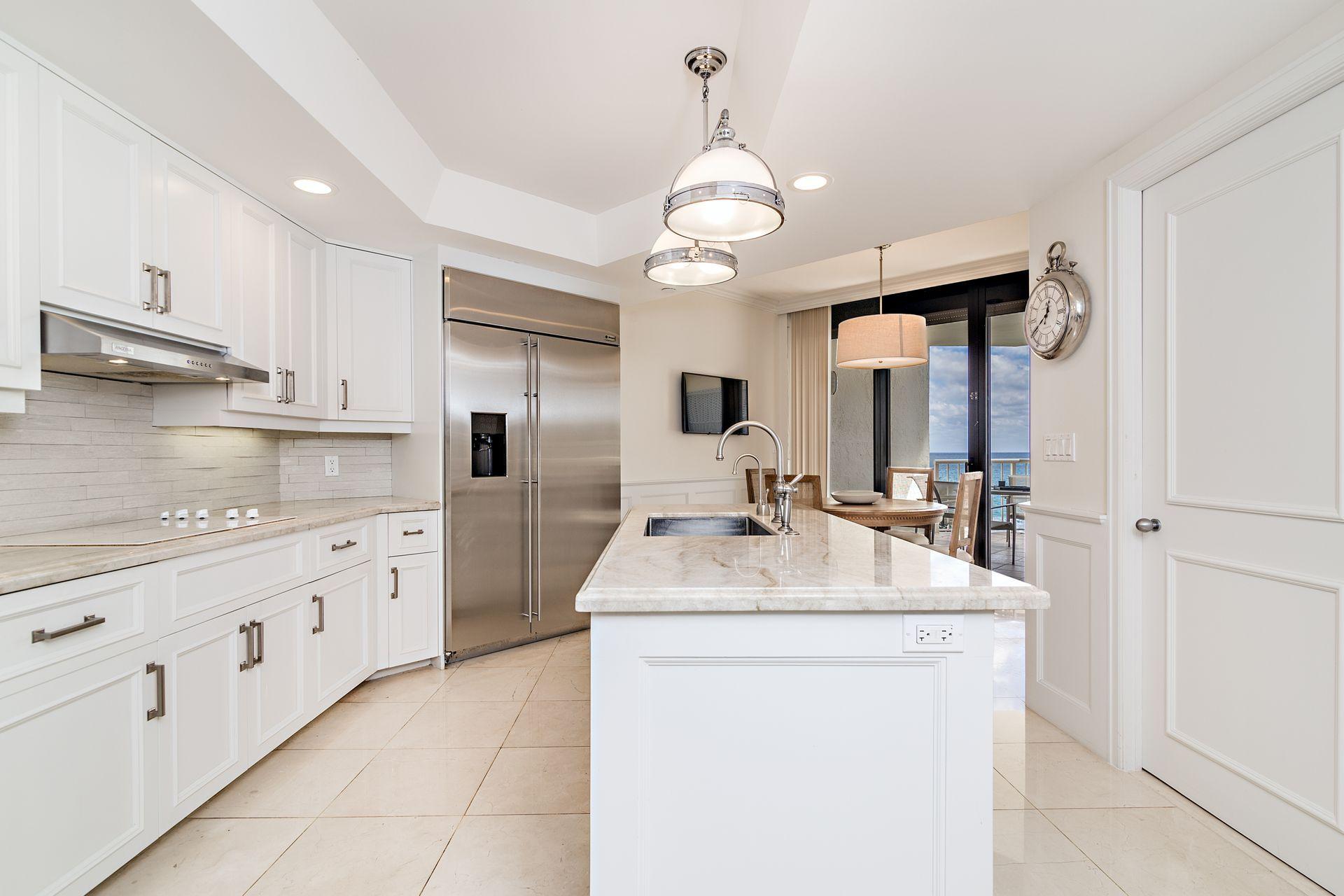 2770 South Ocean Boulevard, Unit 401S Palm Beach, FL 33480 - Photo 9 of 40 a kitchen with sink cabinets and refrigerator