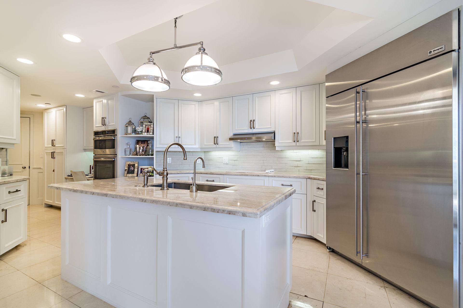 2770 South Ocean Boulevard, Unit 401S Palm Beach, FL 33480 - Photo 10 of 40 a kitchen with stainless steel appliances granite countertop a sink refrigerator and cabinets