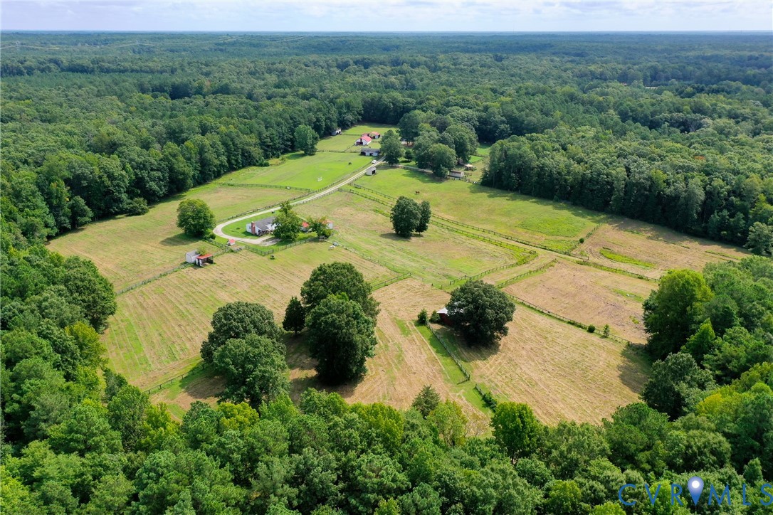 an aerial view of a house with yard and outdoor seating