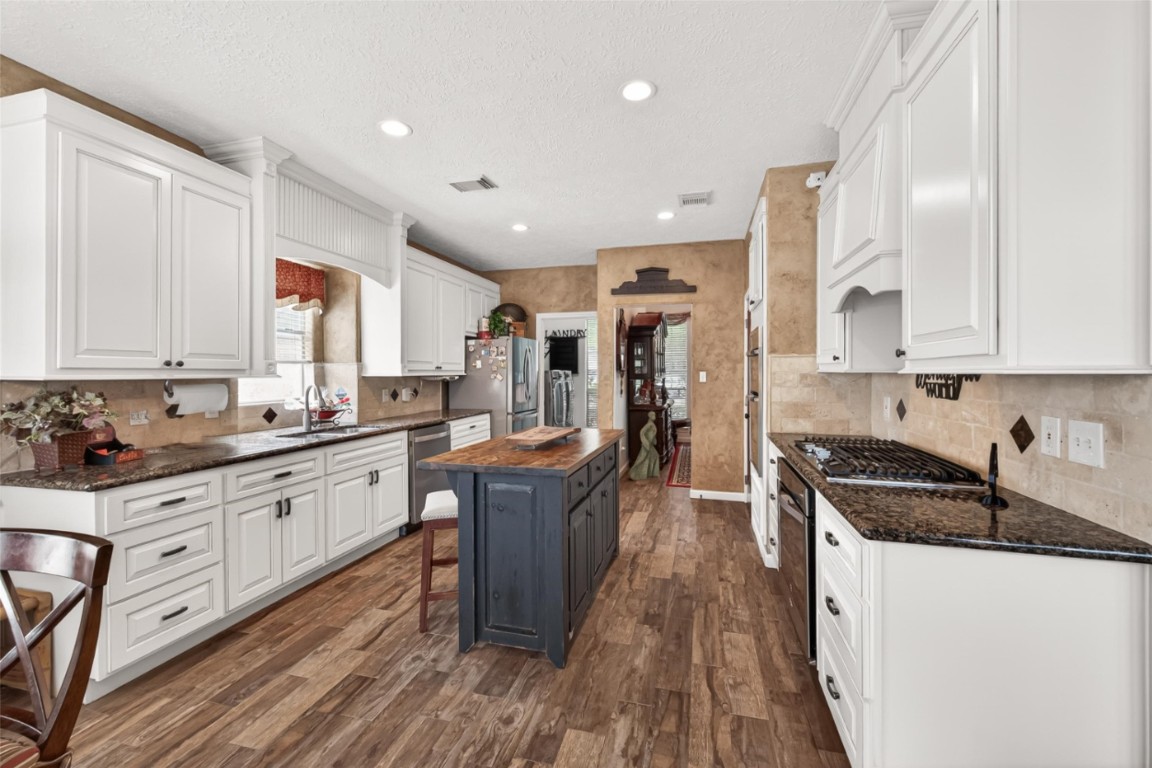 3506 Hunstanton Court Katy, TX 77450 - Photo 20 of 50 a kitchen with granite countertop a sink a counter top space stainless steel appliances and cabinets