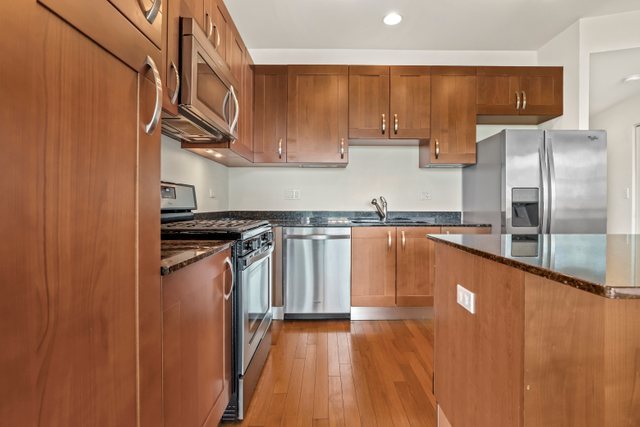 225 South Sangamon Street, Unit 412 Chicago, IL 60607 - Photo 11 of 29 a kitchen with stainless steel appliances granite countertop a refrigerator a sink and a stove