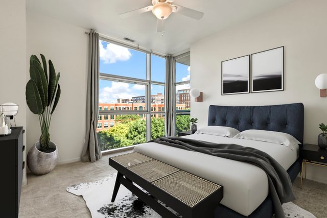 225 South Sangamon Street, Unit 412 Chicago, IL 60607 - Photo 13 of 29 a bedroom with a bed a mirror and a large window