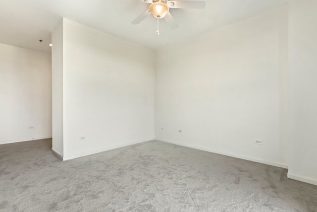 225 South Sangamon Street, Unit 412 Chicago, IL 60607 - Photo 16 of 29 an empty room with a ceiling fan and a window