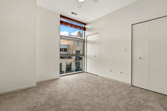 225 South Sangamon Street, Unit 412 Chicago, IL 60607 - Photo 19 of 29 a view of an empty room with a glass door and a window