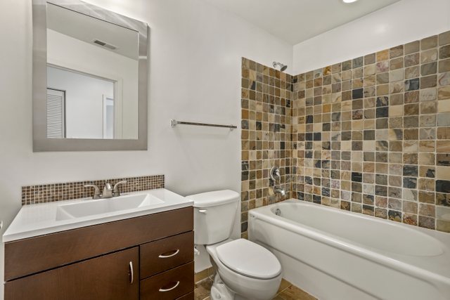 225 South Sangamon Street, Unit 412 Chicago, IL 60607 - Photo 21 of 29 a bathroom with a sink a toilet and shower