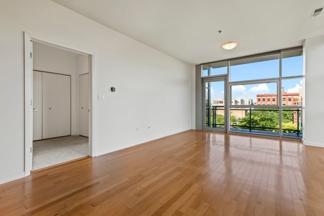 225 South Sangamon Street, Unit 412 Chicago, IL 60607 - Photo 5 of 29 wooden floor in an empty room with a window