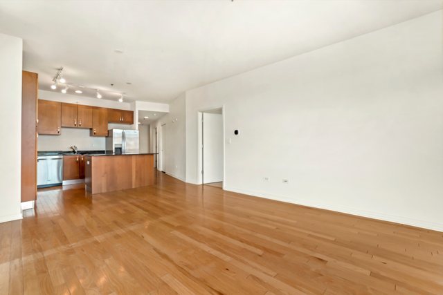 225 South Sangamon Street, Unit 412 Chicago, IL 60607 - Photo 7 of 29 a view of kitchen with kitchen island and stainless steel appliances