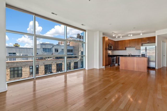 225 South Sangamon Street, Unit 412 Chicago, IL 60607 - Photo 9 of 29 a view of a big room with wooden floor and windows