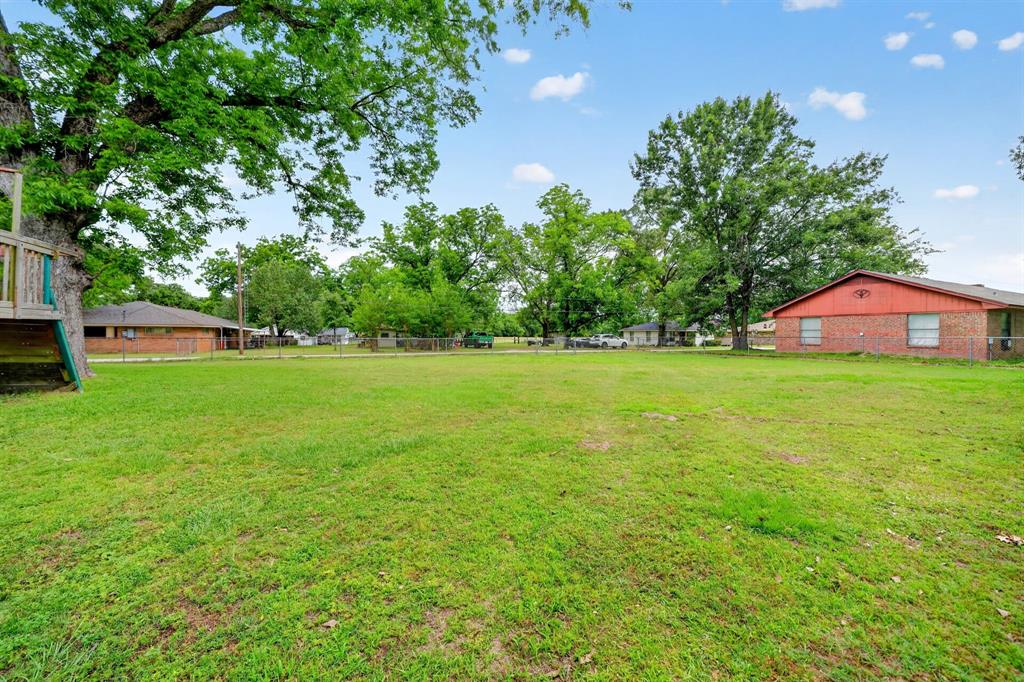 610 Crooked Creek Road Edgewood, TX 75117 - Photo 26 of 33 a view of a green field with wooden fence