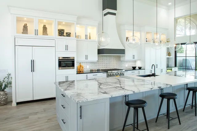 a kitchen with stainless steel appliances kitchen island granite countertop a sink and cabinets