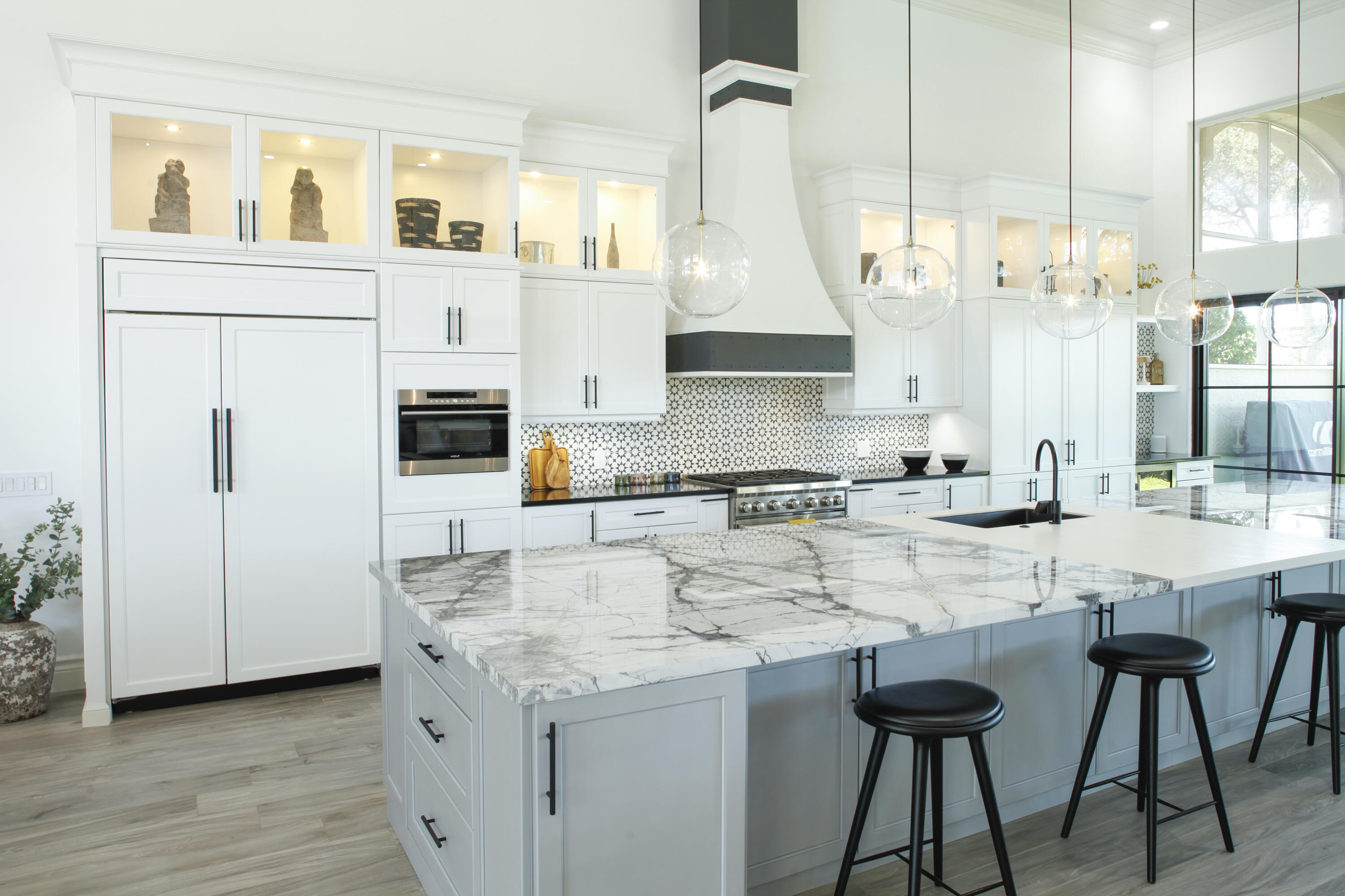 2555 Northwest 59th Street Boca Raton, FL 33496 - Photo 11 of 33 a kitchen with stainless steel appliances kitchen island granite countertop a sink and cabinets