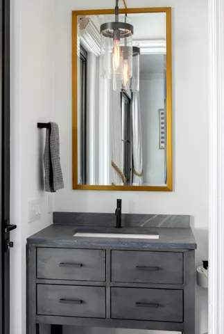 a bathroom with a black and white checkered floor