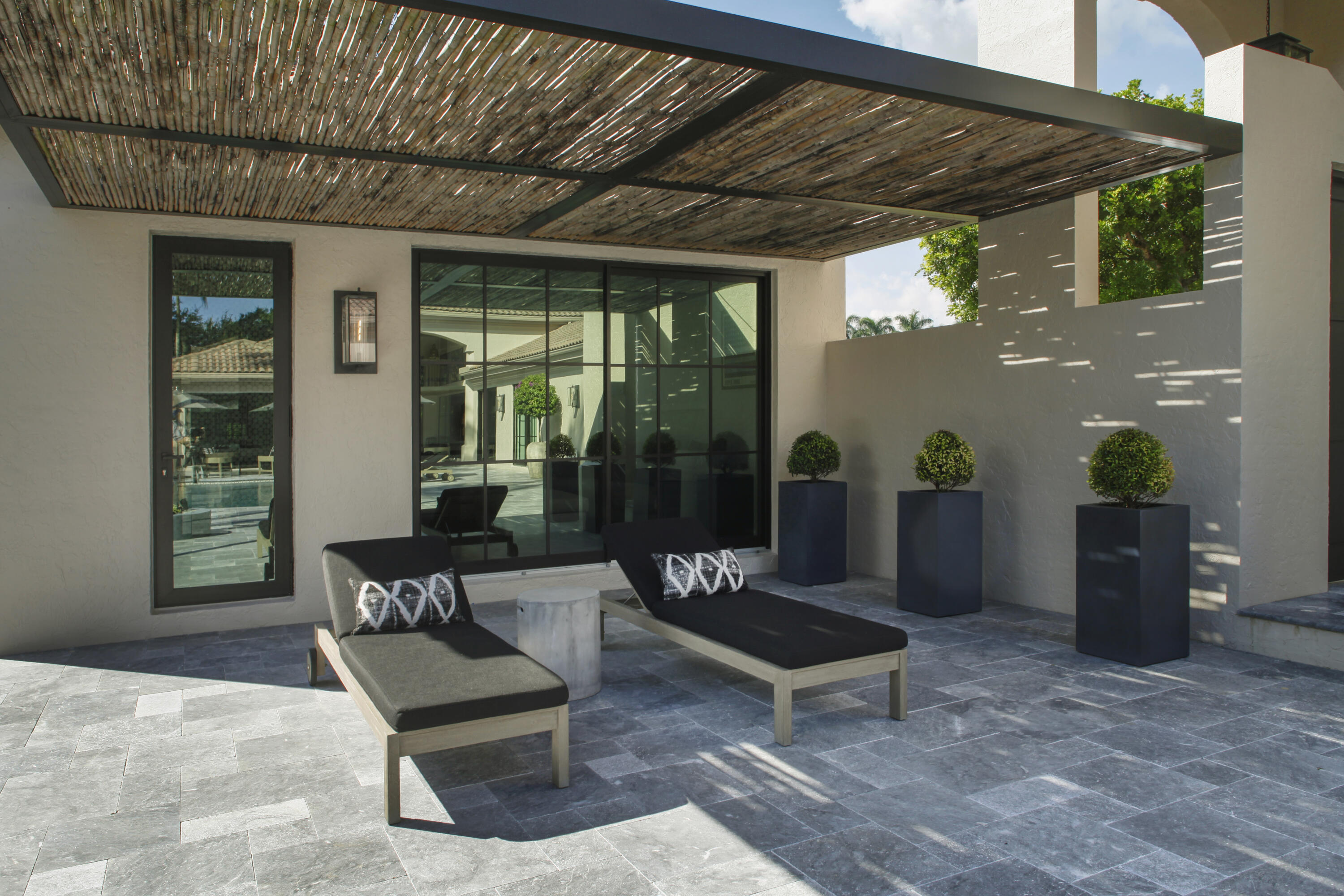 2555 Northwest 59th Street Boca Raton, FL 33496 - Photo 15 of 33 a building outdoor space with patio furniture and potted plants