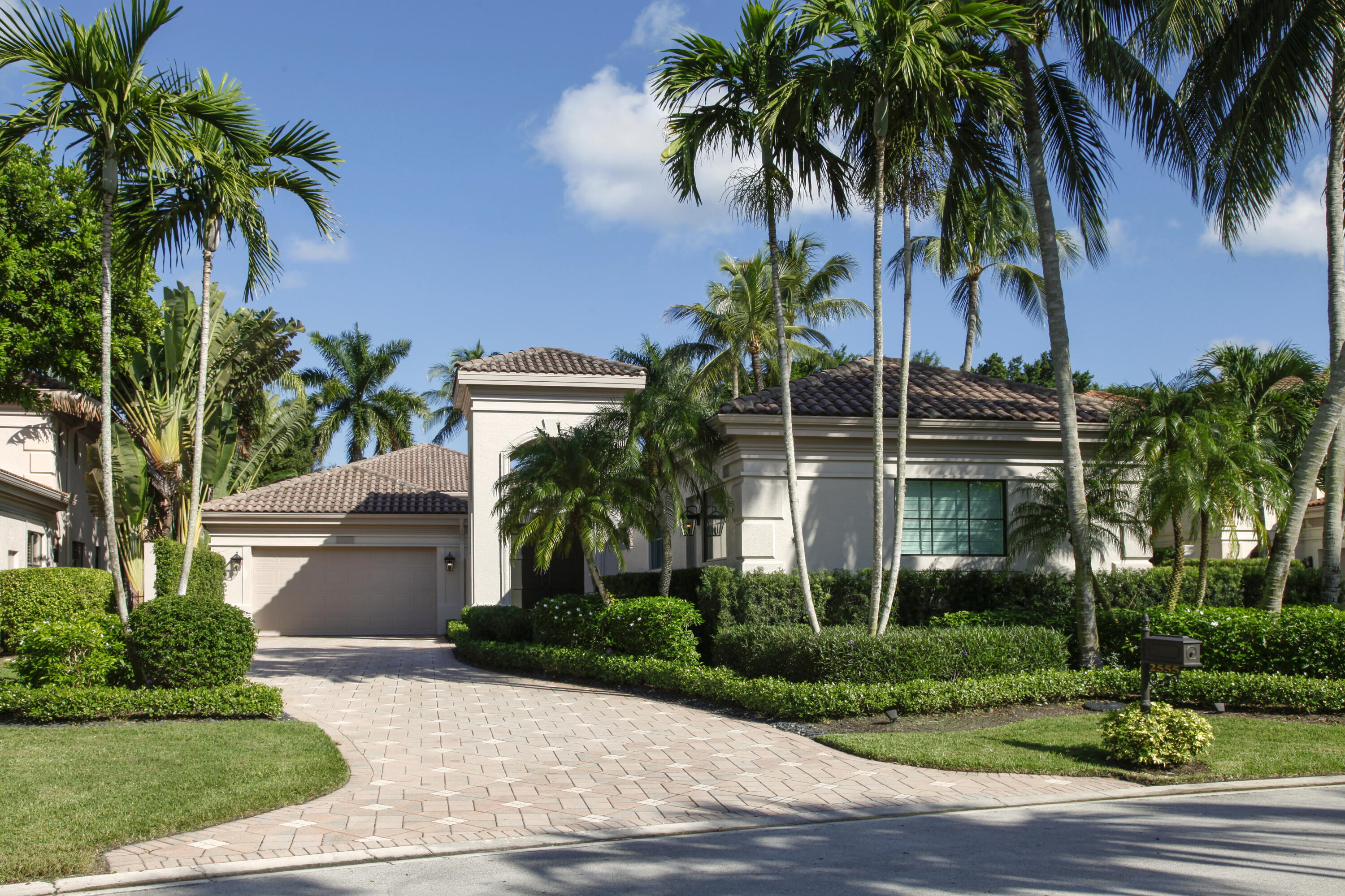 2555 Northwest 59th Street Boca Raton, FL 33496 - Photo 18 of 33 a front view of house with small garden and palm trees