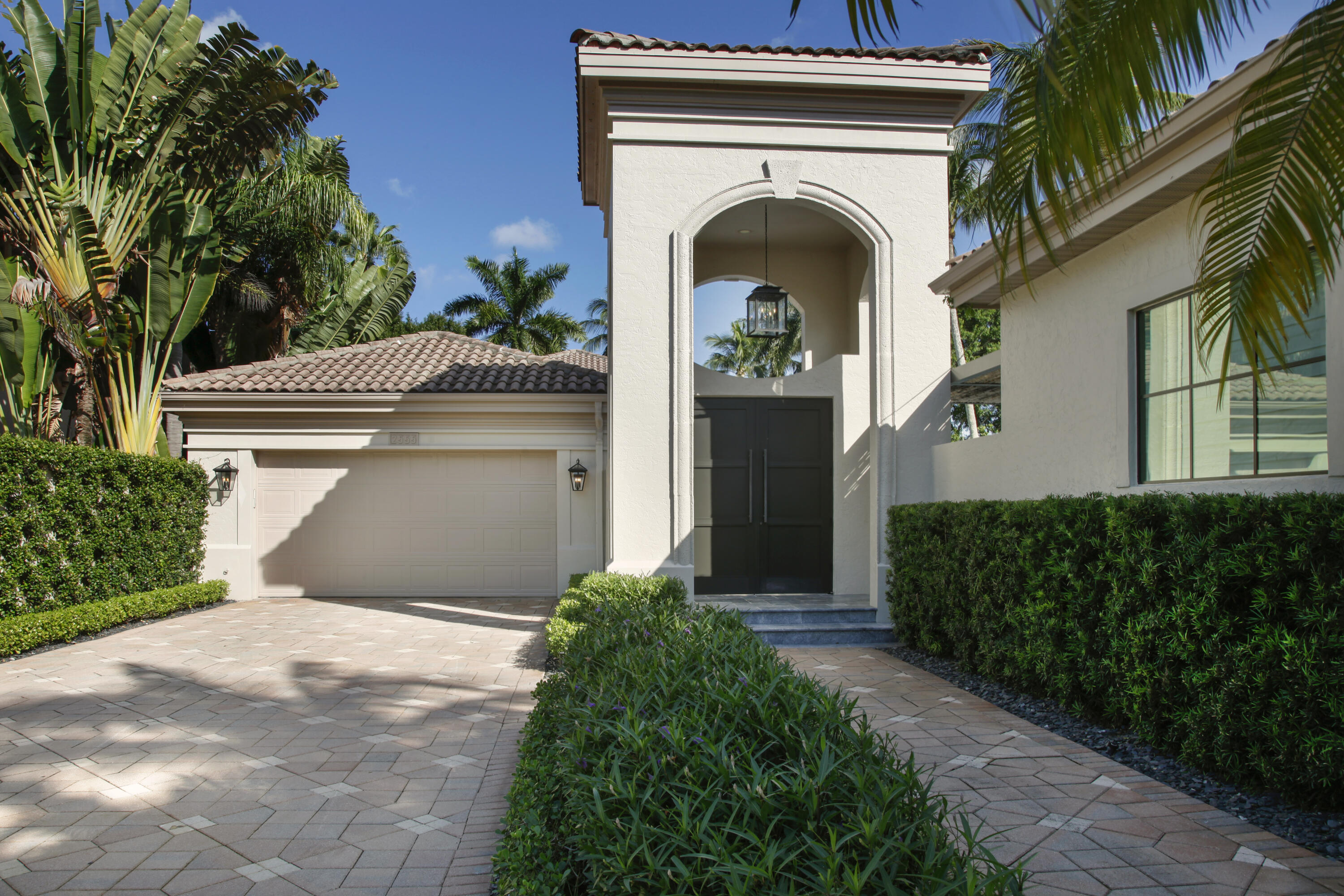 2555 Northwest 59th Street Boca Raton, FL 33496 - Photo 19 of 33 a front view of a house with entryway and plants