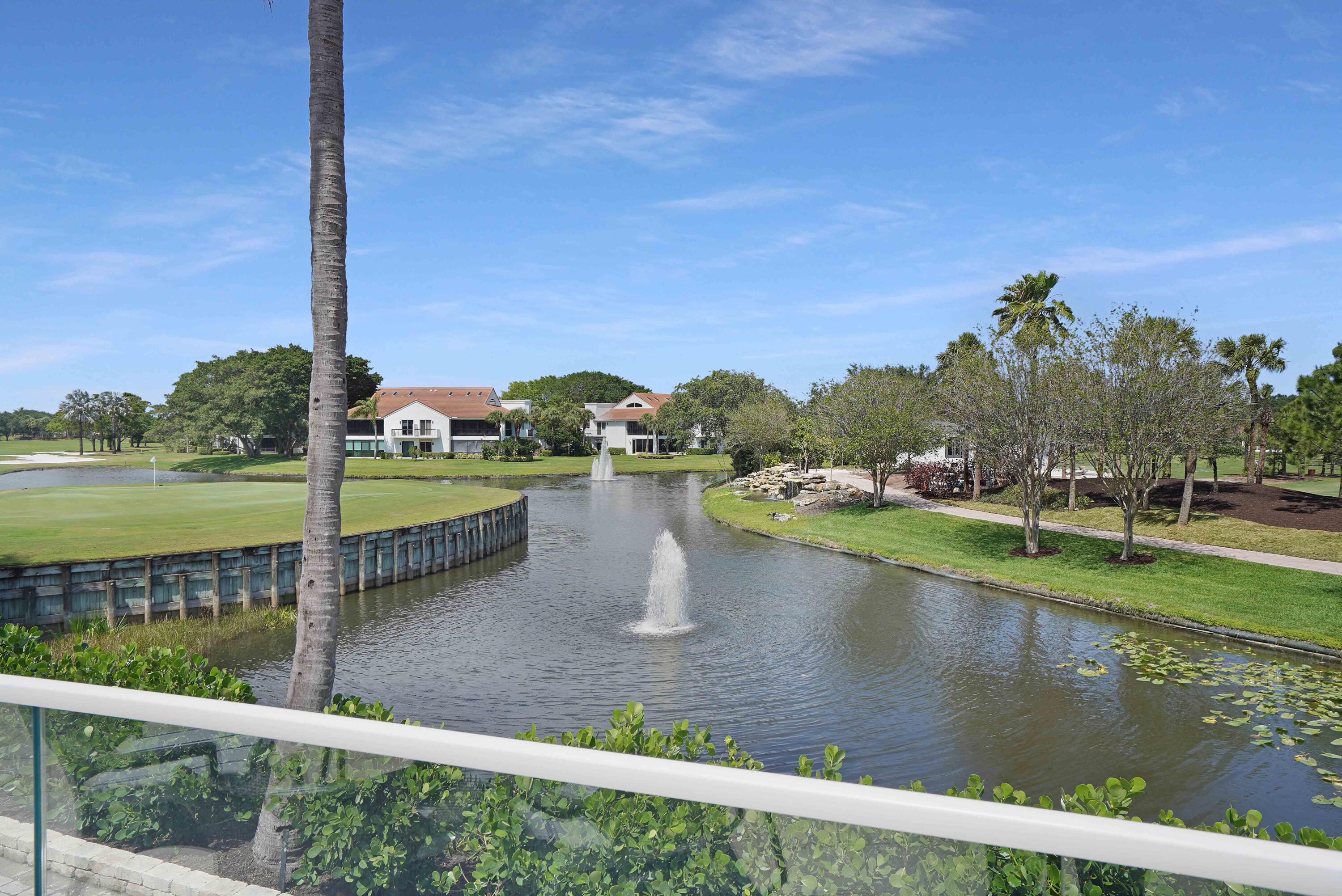 2555 Northwest 59th Street Boca Raton, FL 33496 - Photo 25 of 33 a view of a lake with a big yard and large trees