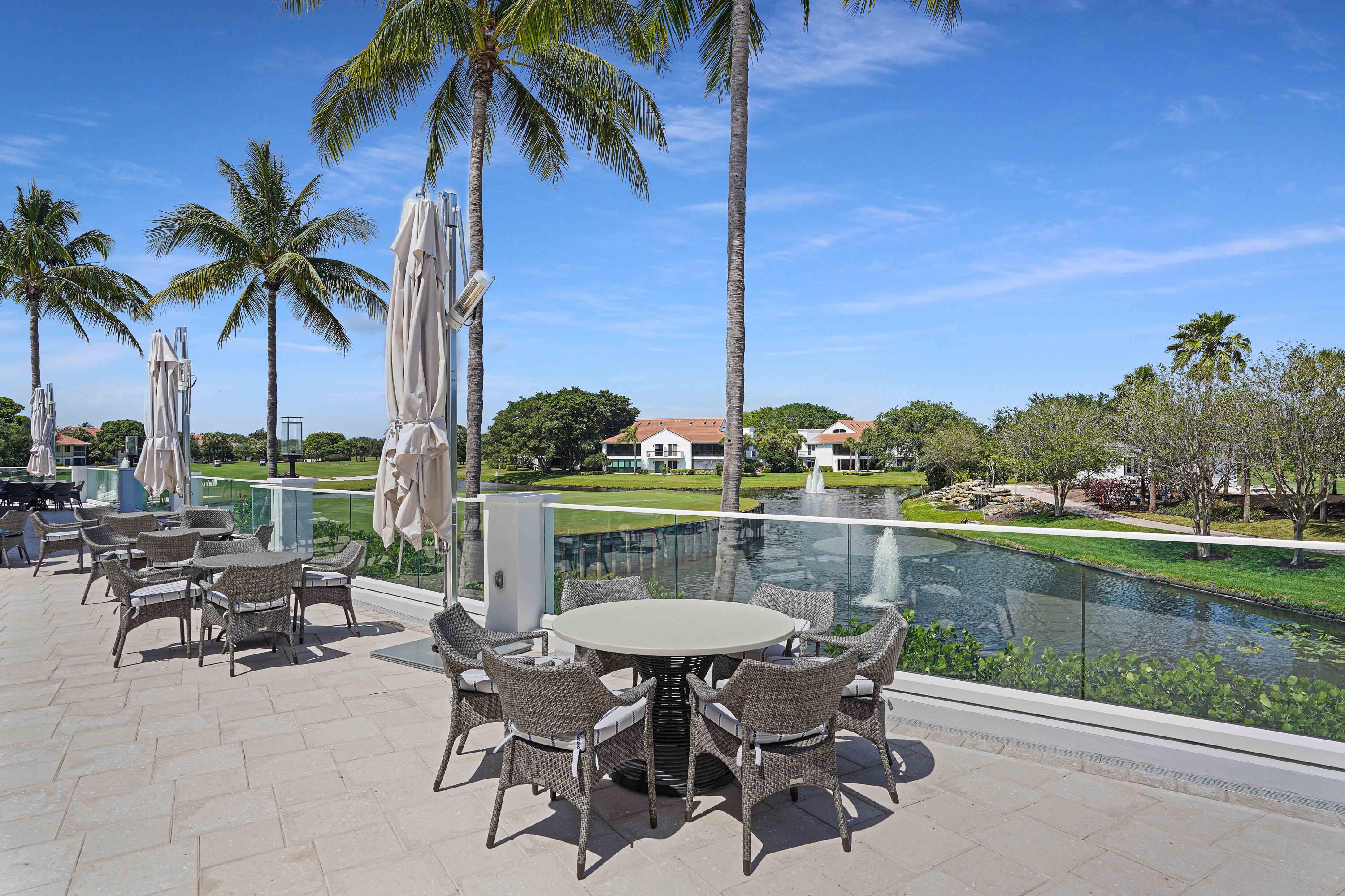 2555 Northwest 59th Street Boca Raton, FL 33496 - Photo 26 of 33 a view of a lake with table and chairs