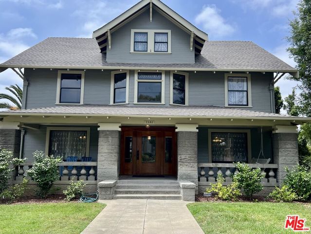 a front view of a house with garden and porch