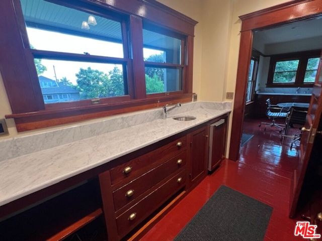 a hallway with a large kitchen space and a sink