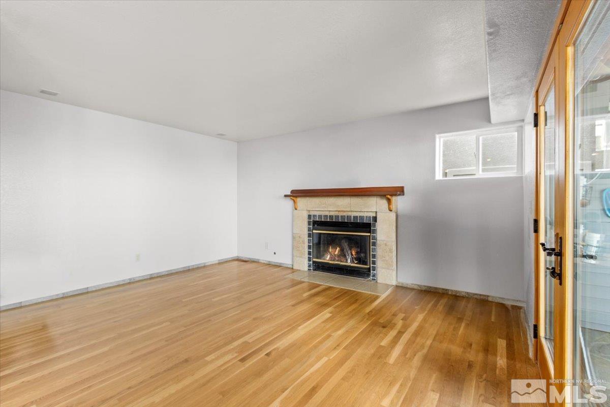 2616 Starr Meadows Loop Reno, NV 89519 - Photo 16 of 39 a view of empty room with a fireplace and wooden floor