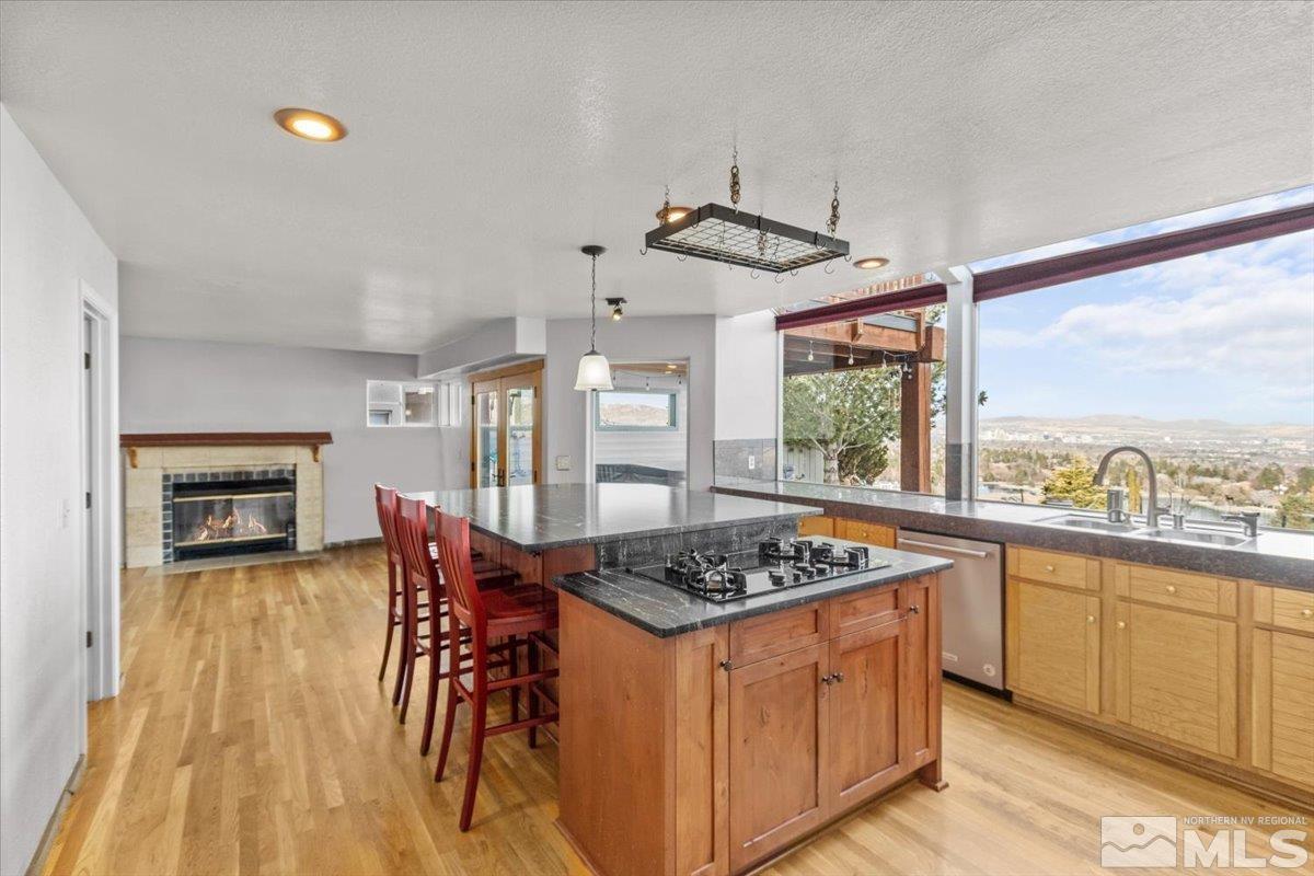 2616 Starr Meadows Loop Reno, NV 89519 - Photo 18 of 39 a kitchen with a stove a sink a dining table and chairs