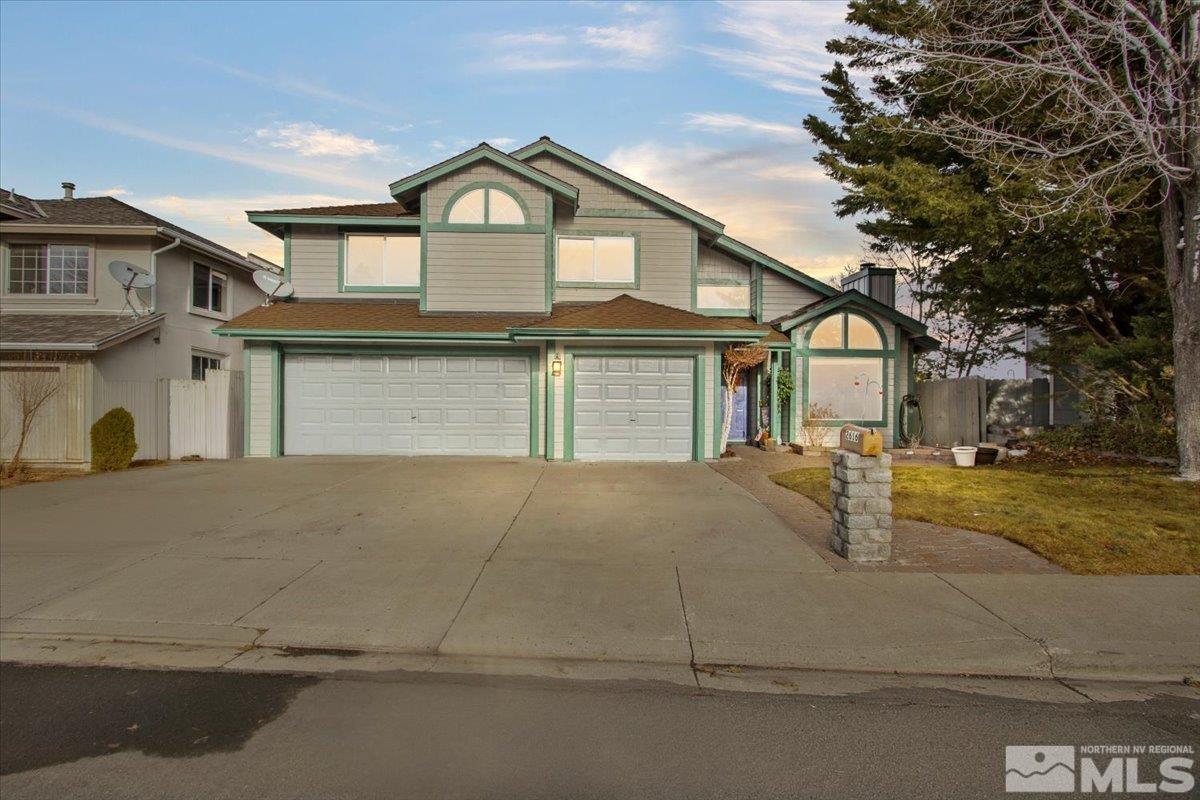 2616 Starr Meadows Loop Reno, NV 89519 - Photo 2 of 39 a front view of a house with a yard and garage