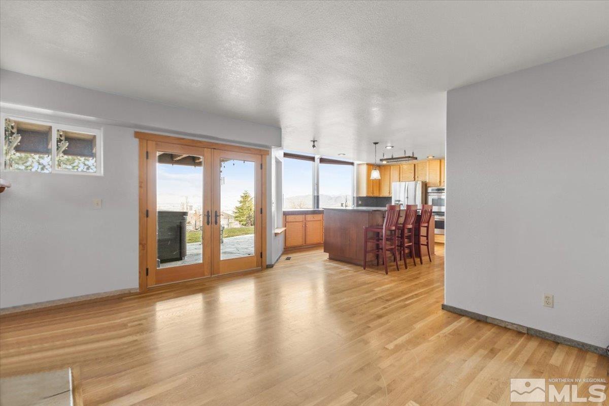 2616 Starr Meadows Loop Reno, NV 89519 - Photo 21 of 39 a view of a living room a kitchen with furniture and wooden floor