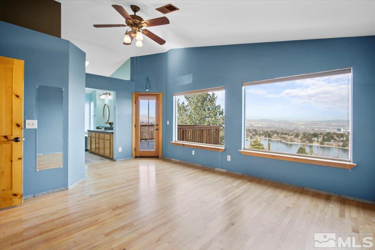 2616 Starr Meadows Loop Reno, NV 89519 - Photo 23 of 39 a view of an empty room with a window and wooden floor