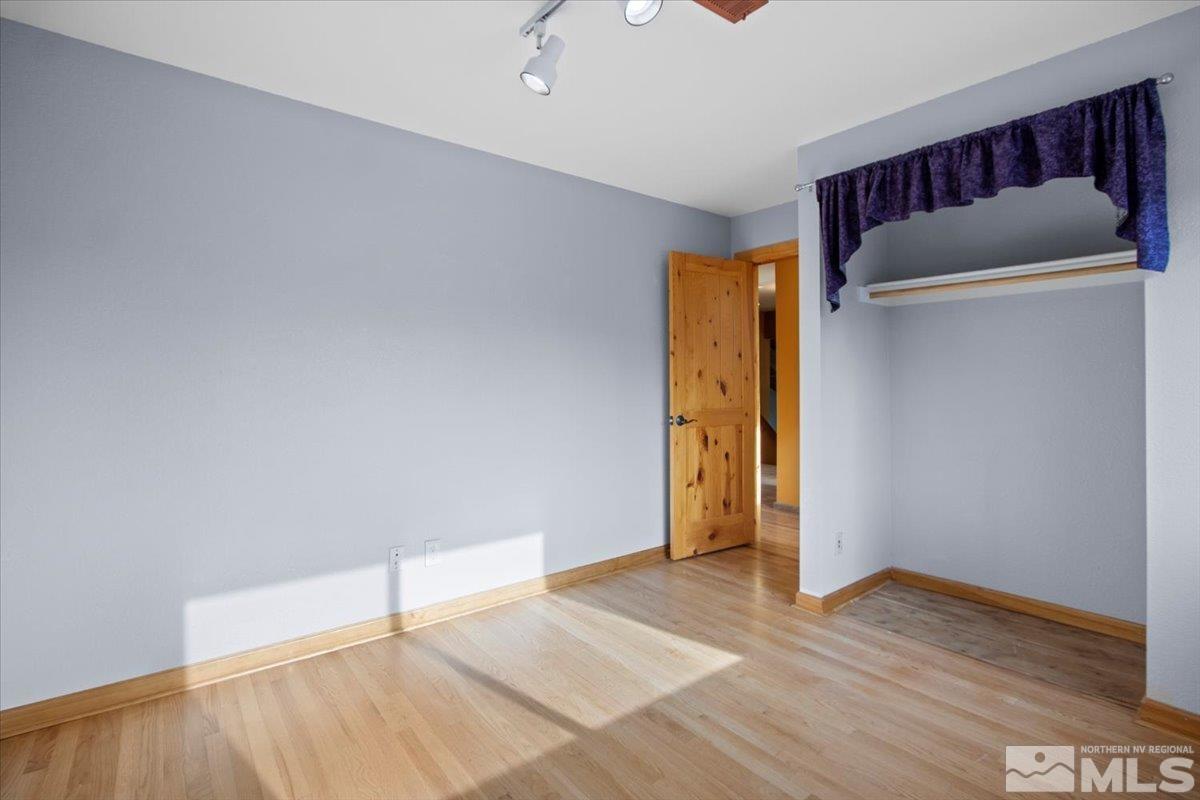 2616 Starr Meadows Loop Reno, NV 89519 - Photo 31 of 39 an empty room with wooden floor and closet