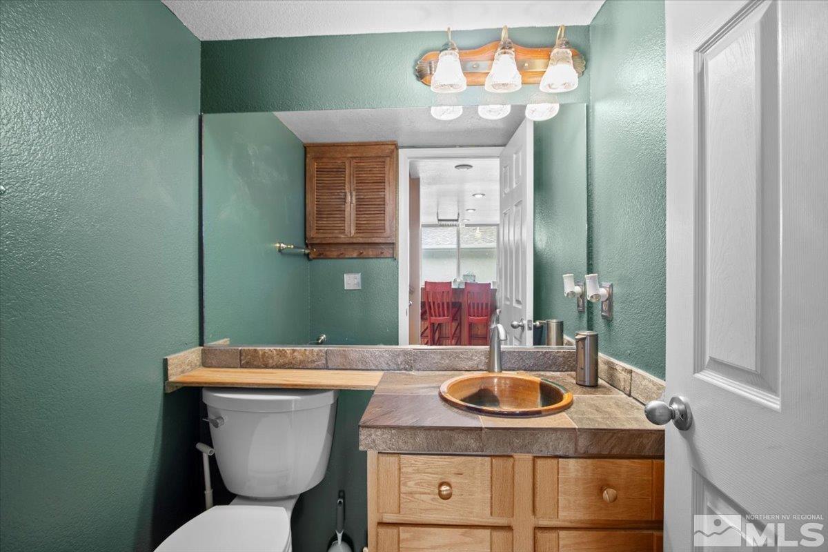 2616 Starr Meadows Loop Reno, NV 89519 - Photo 32 of 39 a bathroom with a sink toilet and mirror