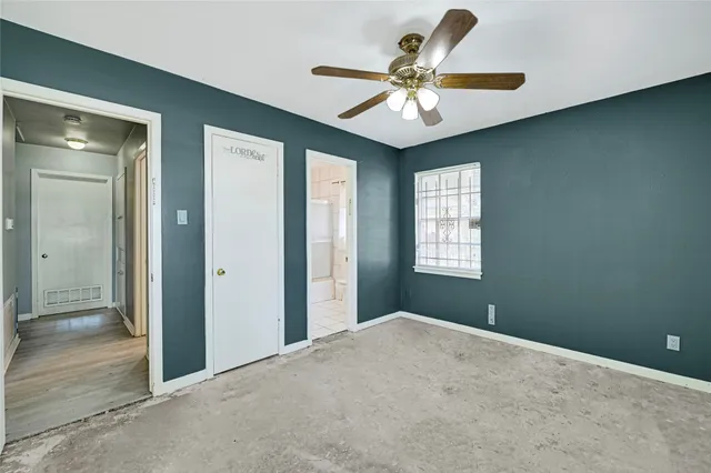 a view of a livingroom with a ceiling fan and window