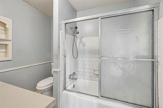 a bathroom with a shower a toilet and a shower