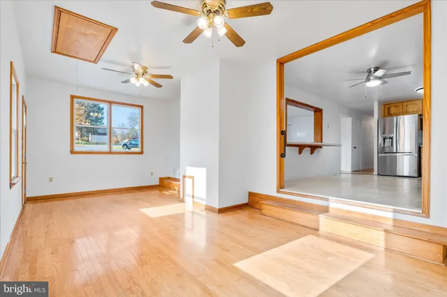 a view of a livingroom with a ceiling fan and window