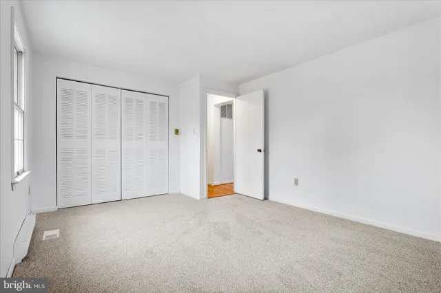 an empty room with windows and a yard