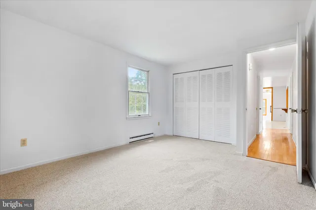 a bathroom with a sink a toilet and a window