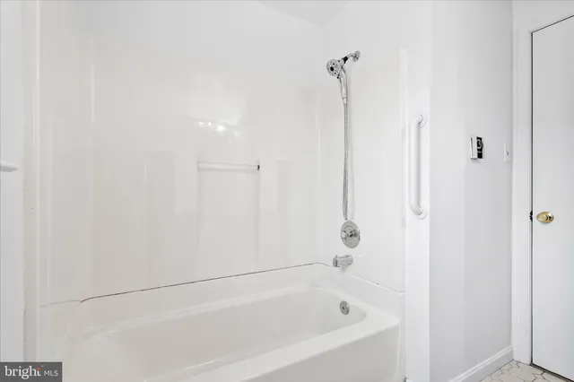 an empty room with chandelier fan